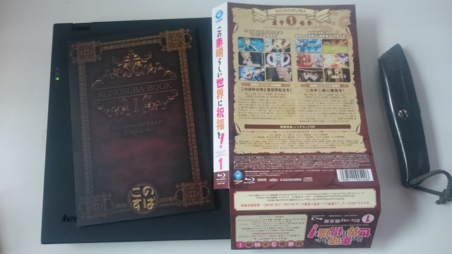 Konosuba book and paper thingy wrapped around half the box
